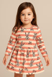 Little girl modeling a long-sleeve dress with horizontal pink and white stripes and black printed graphics of Bugs Bunny and "Bugs Bunny" text.
